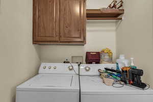 Laundry room with cabinet space and washing machine and dryer