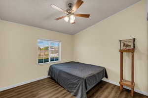 Bedroom featuring dark wood finished floors and ceiling fan