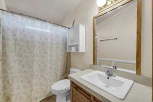 Full bath featuring vanity, a shower with shower curtain, and a textured ceiling