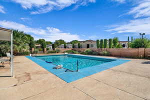 Community pool featuring a patio