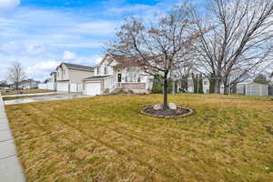 View of yard featuring driveway and an attached garage