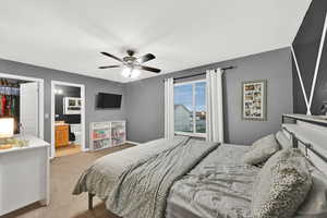 Bedroom with light carpet, a ceiling fan, and a closet