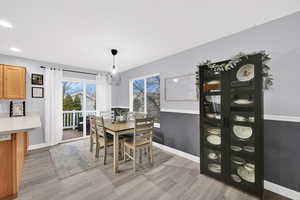 Dining space with light wood finished floors and recessed lighting