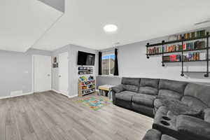 Living area featuring light wood-type flooring and baseboards