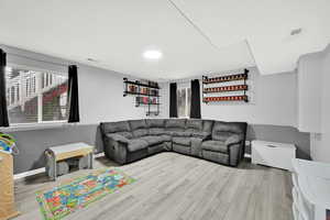 Living area featuring light wood finished floors and healthy amount of natural light