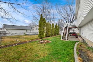 Fenced backyard with a patio area and a deck