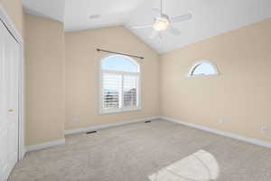 Unfurnished bedroom featuring light colored carpet, a closet, and ceiling fan