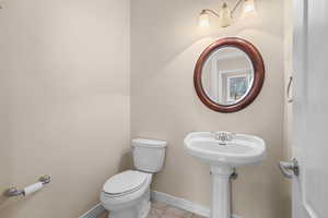 Bathroom featuring toilet and light tile patterned floors