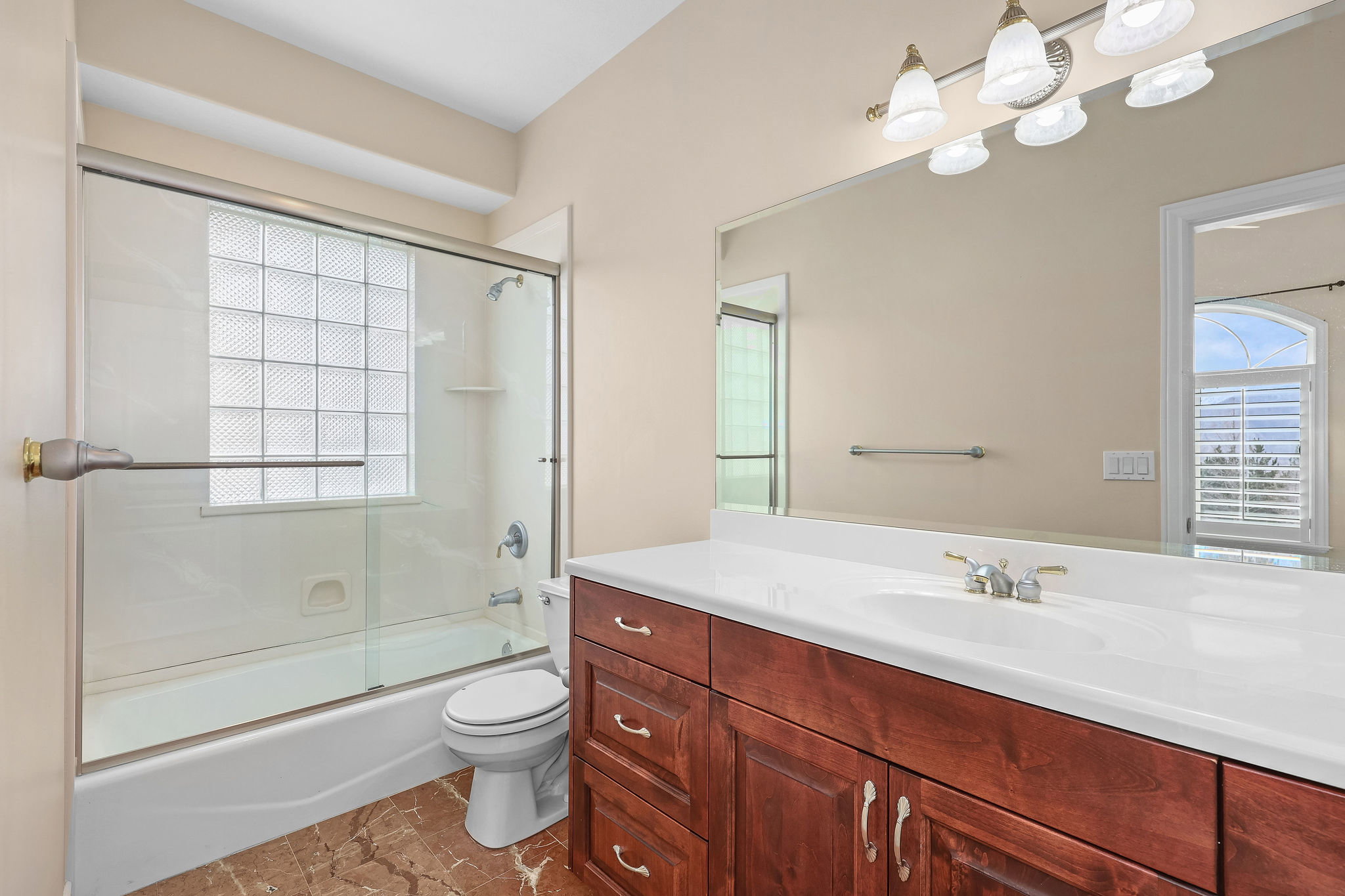 Full bath featuring vanity and shower / bath combination with glass door