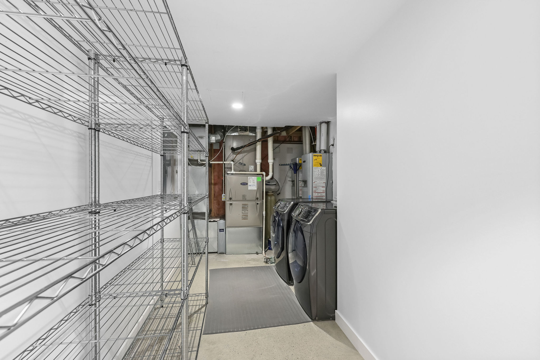 Laundry area with washer and clothes dryer, gas water heater, and heating unit
