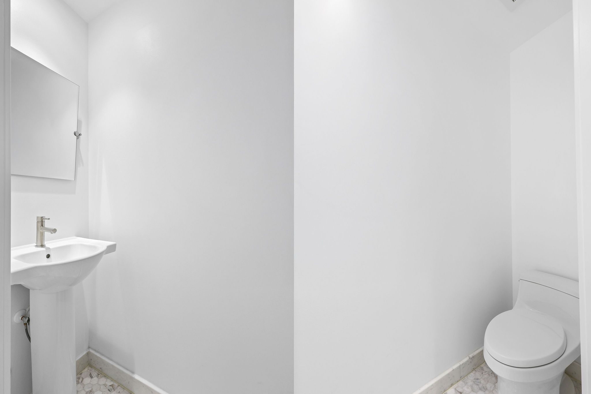 Bathroom featuring baseboards and toilet