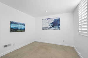 Empty room featuring concrete floors and recessed lighting