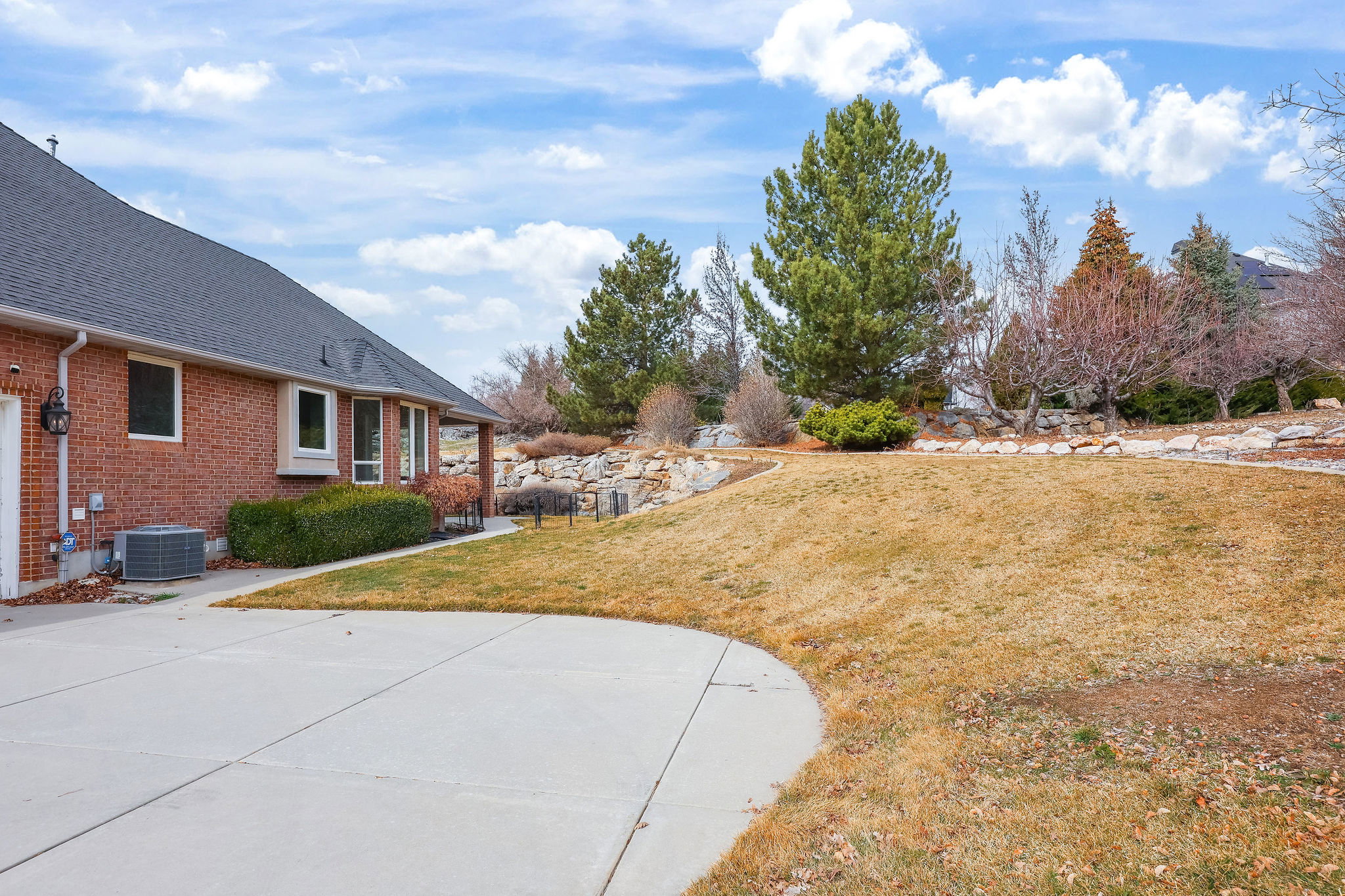 View of grassy yard featuring a patio area