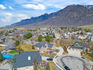 Aerial view of residential area featuring a mountainous background