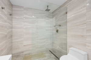 Full bath featuring walk in shower and tile walls