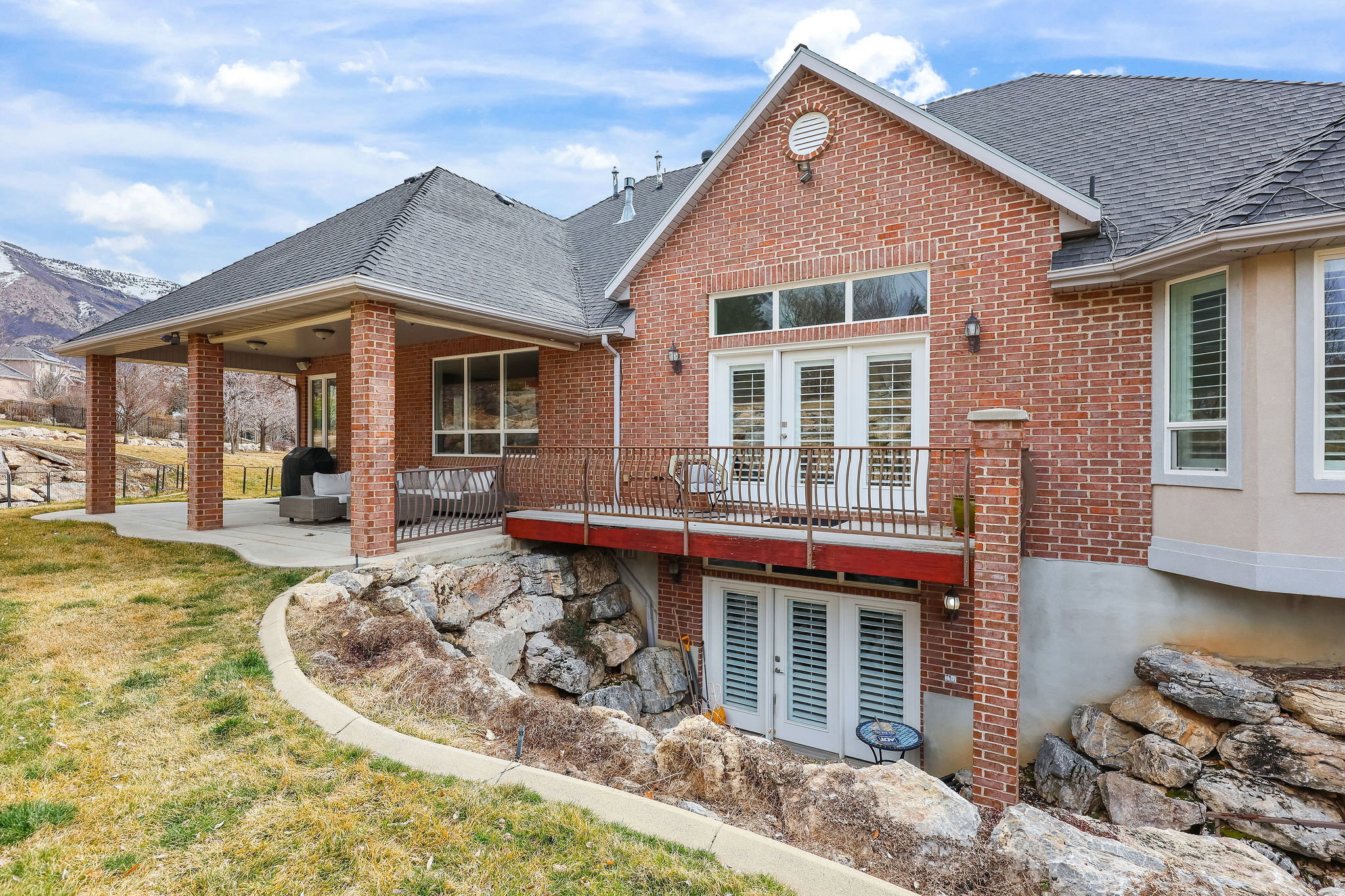 Back of house featuring french doors, a patio, brick siding, a shingled roof, and a yard