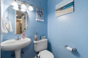 Half bathroom featuring toilet and a sink