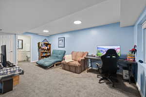 Living/Office space with light carpet and baseboards