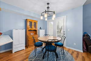 Dining area with ceramic wood tile floors and upgraded lighting