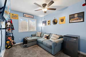 Bedroom featuring carpet, ceiling fan, and a textured ceiling
