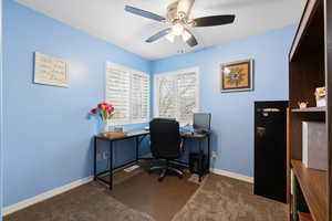 Bedroom with dark carpet and ceiling fan