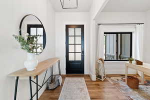 Entrance foyer with light wood-style floors and baseboards