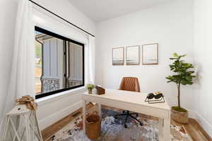 Home office with wood finished floors and baseboards