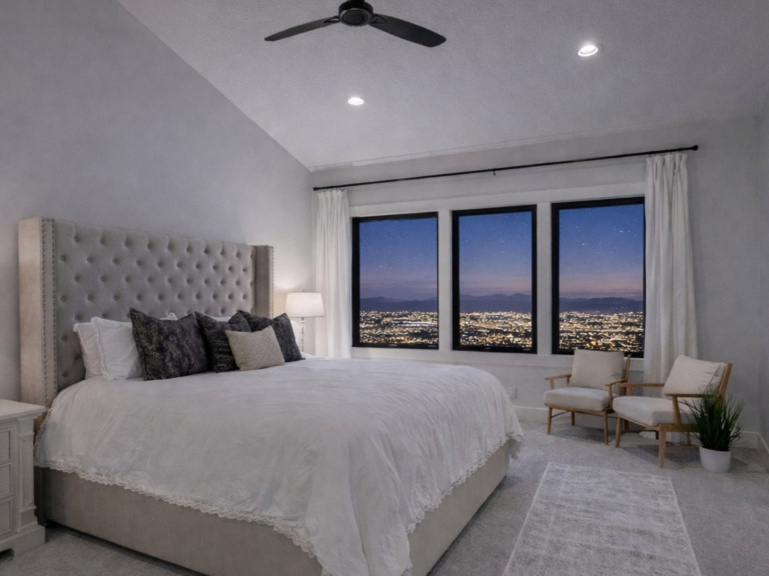 Bedroom with vaulted ceiling and a ceiling fan