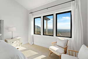 Bedroom with lofted ceiling, light carpet, and a mountain view