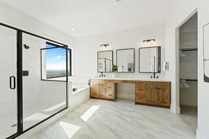 Full bathroom with double vanity, a bath, a stall shower, a spacious closet, and light marble finish flooring