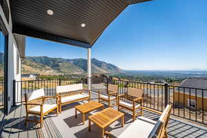 Deck featuring a patio area, a mountain view, and outdoor furniture