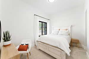 Bedroom featuring light colored carpet and lofted ceiling