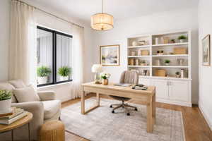 Office with light wood-style flooring and baseboards