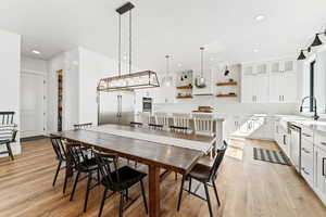 Dining area with light wood-type flooring and recessed lighting