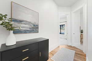 Corridor with light wood finished floors and baseboards