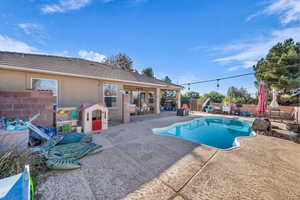 View of pool with patio surround and a fenced backyard