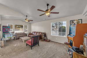 Living room with light carpet, lofted ceiling, and a ceiling fan