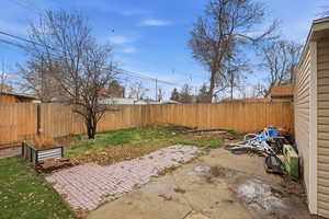 Fenced backyard featuring a patio