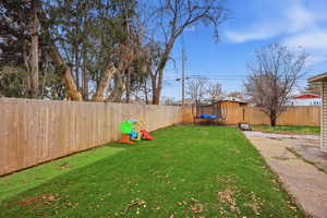Fenced backyard with a trampoline
