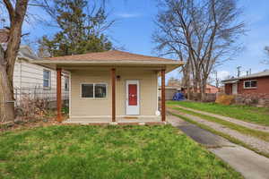 View of front of property with a porch and roof with shingles
