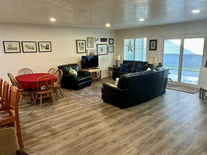 Living room featuring a textured ceiling, wood finished floors, and recessed lighting