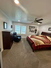 Carpeted bedroom with recessed lighting, a textured ceiling, and ceiling fan
