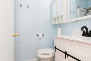 Bathroom featuring vanity and toilet