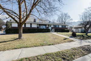 Ranch-style home with a chimney and a front yard