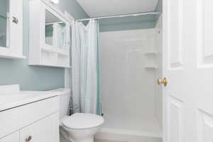 Full bathroom featuring vanity and a stall shower