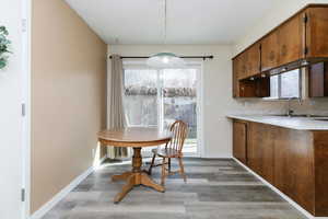 Dining area featuring light wood-style floors and healthy amount of natural light