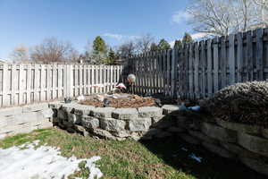 Fenced backyard with a garden pond