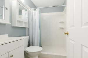 Full bathroom with vanity and a shower stall