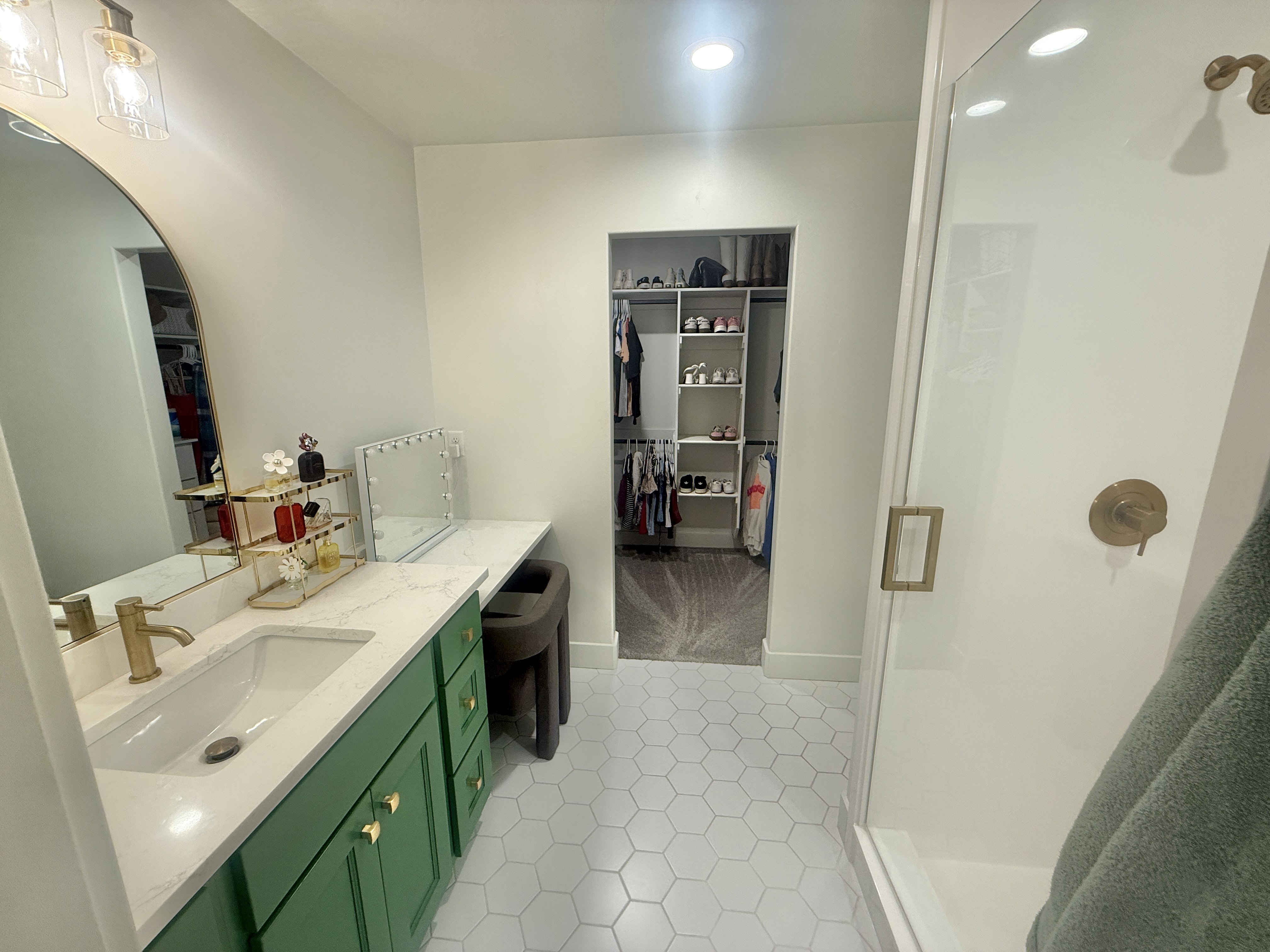 Full bathroom with vanity, a walk in closet, a stall shower, light tile patterned floors, and recessed lighting