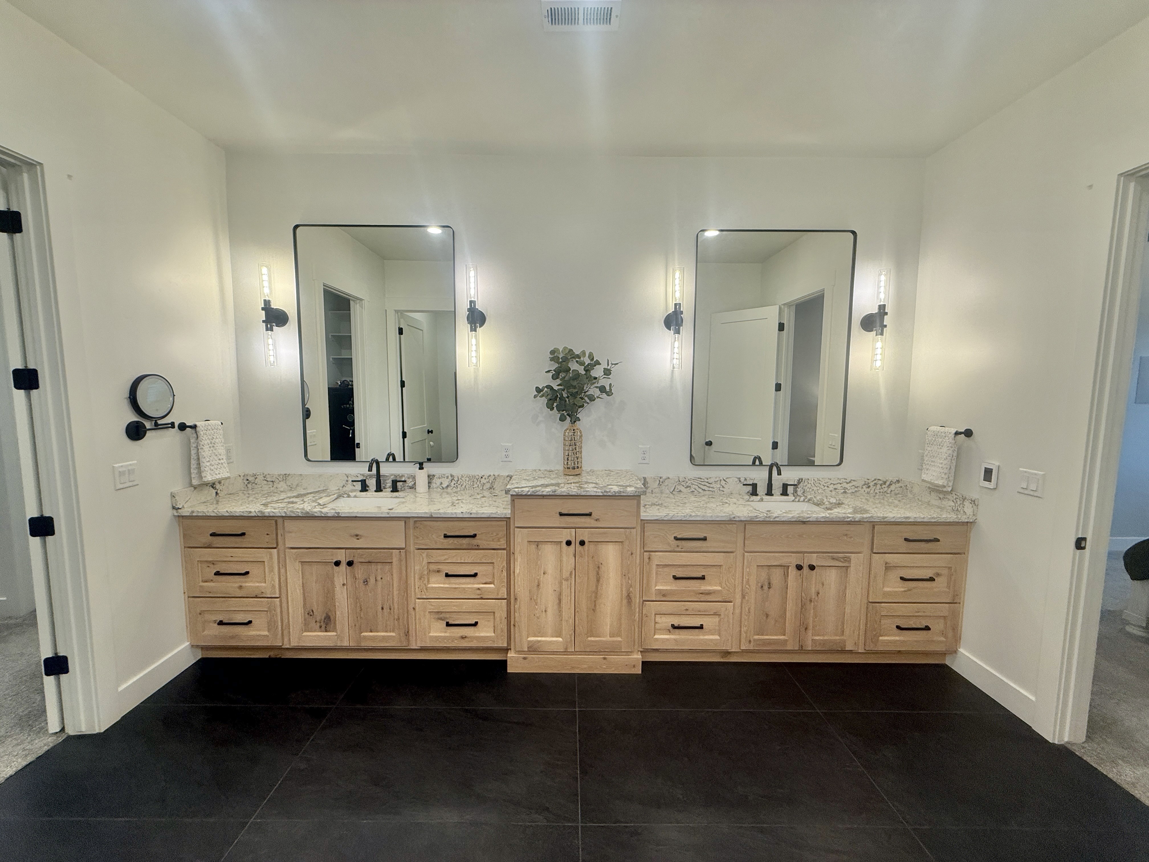 Bathroom with vanity and dark tile patterned flooring